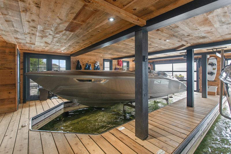 Cedar boathouse with premium boat on hydraulic lift
